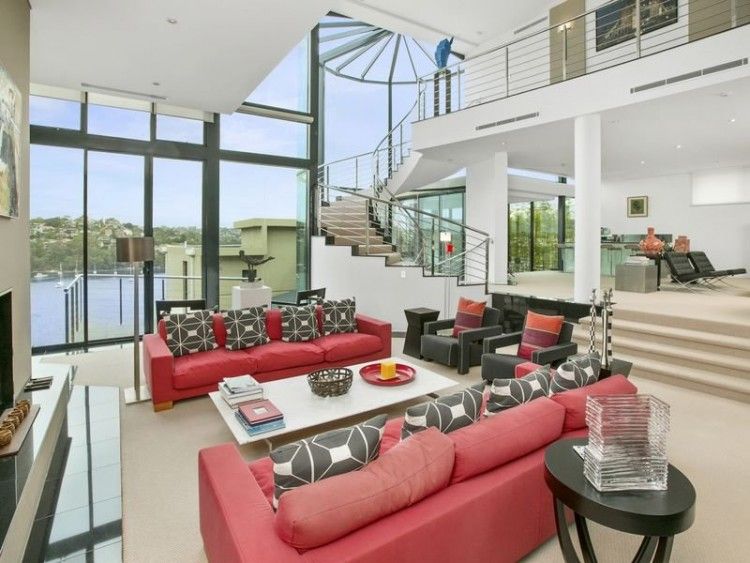 The living area, complete with fireplace and waterfront view