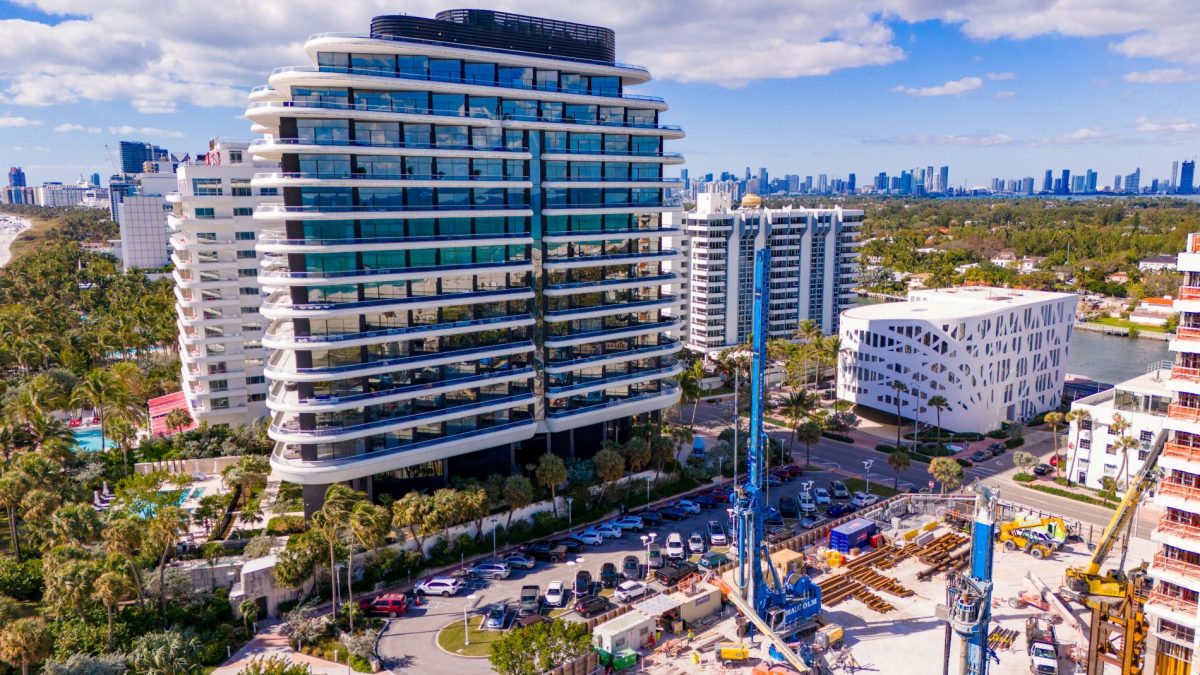 Aerial view of Faena Miami Beach showcasing modern architecture alongside palm trees and construction activity.