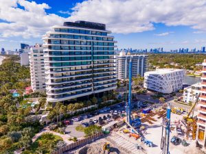 Aerial view of Faena Miami Beach showcasing modern architecture alongside palm trees and construction activity.