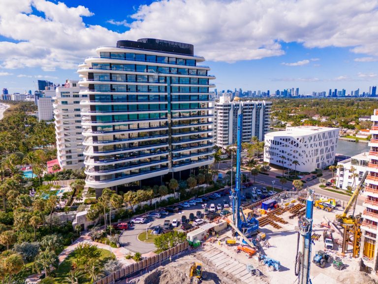 Aerial view of Faena Miami Beach showcasing modern architecture alongside palm trees and construction activity.