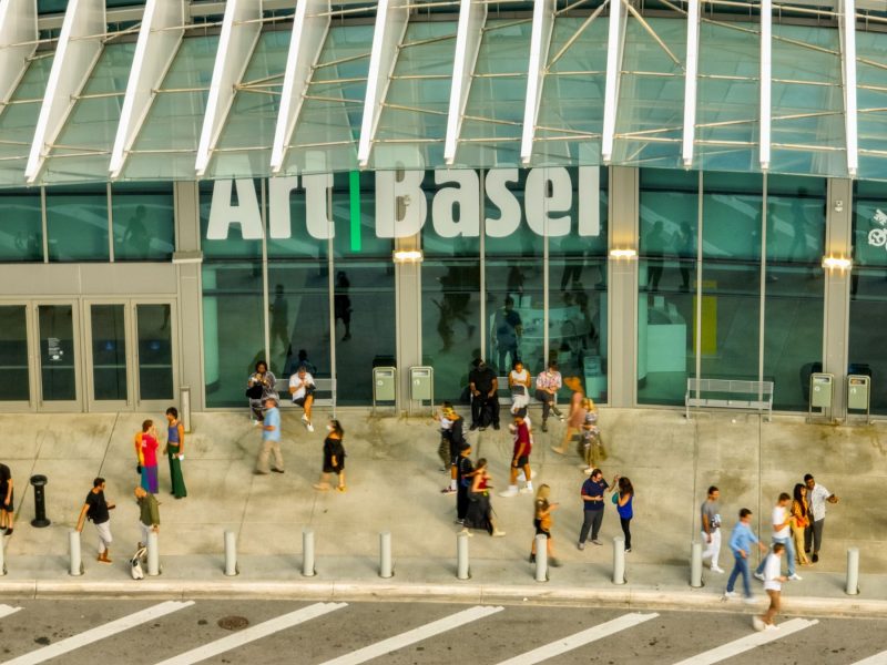 Crowds gather outside the Art Basel venue, showcasing the vibrant atmosphere of Miami's art scene.