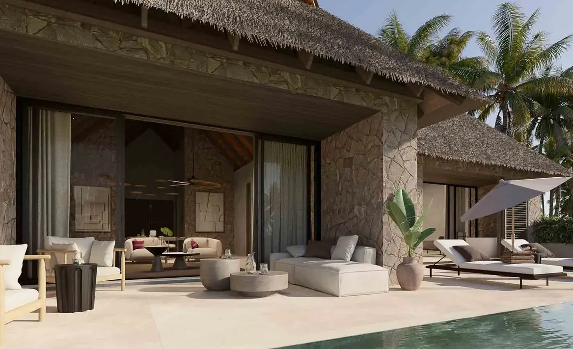 Luxury villa terrace featuring stone walls, modern seating, and a pool surrounded by palm trees at a Palladium hotel.