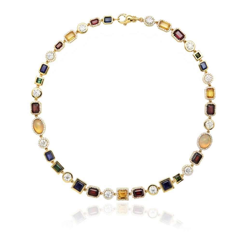 A gold necklace featuring an array of colorful gemstones and diamonds, reflecting high-jewelry glamour.