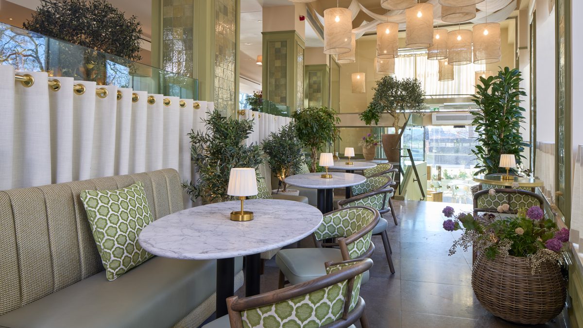 Interior of Tortello in Lancaster Gate, showcasing elegant tables, greenery, and soft lighting for a welcoming Italian dining experience.