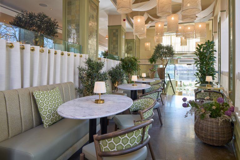 Interior of Tortello in Lancaster Gate, showcasing elegant tables, greenery, and soft lighting for a welcoming Italian dining experience.