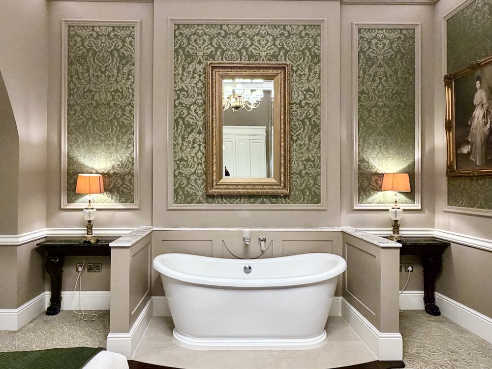 Elegant bathroom at Cabra Castle featuring a freestanding tub, vintage décor, and soft lighting for a charming atmosphere.