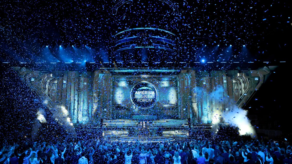 Confetti fills the air as a large crowd celebrates the inaugural America Business Forum in Miami.