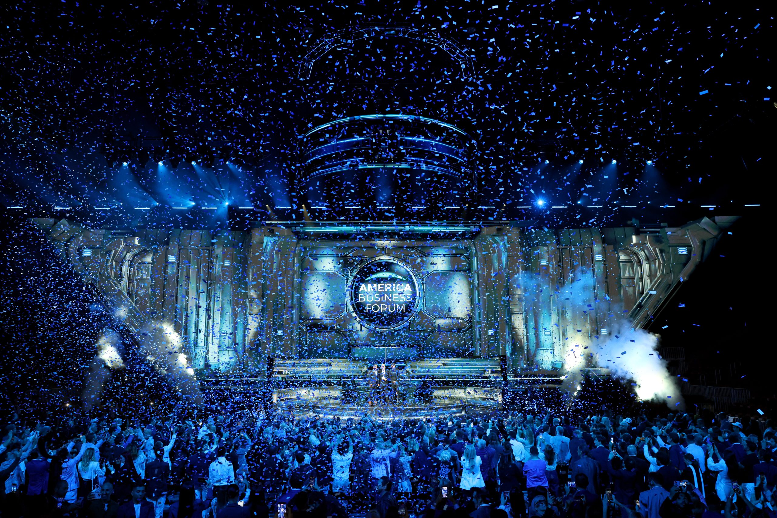 Confetti fills the air as a large crowd celebrates the inaugural America Business Forum in Miami.