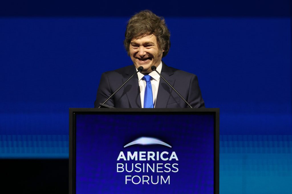 A speaker delivers remarks at the America Business Forum in Miami, highlighting key figures in sports, business, culture, and politics.