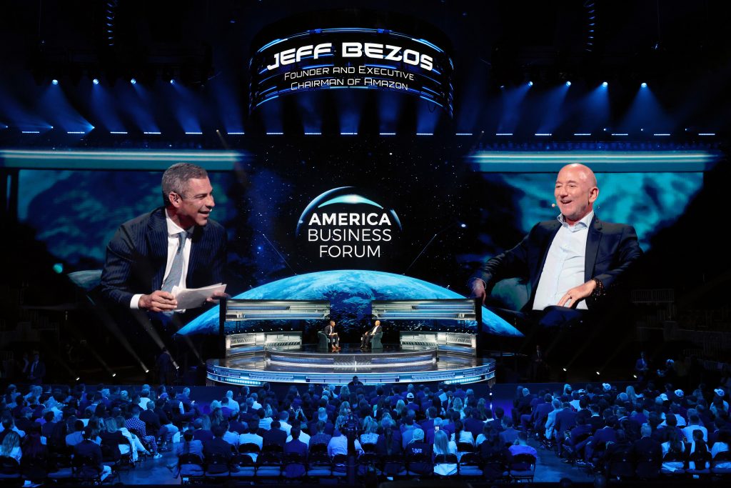 Jeff Bezos participates in a discussion at the America Business Forum, addressing a large audience in Miami.