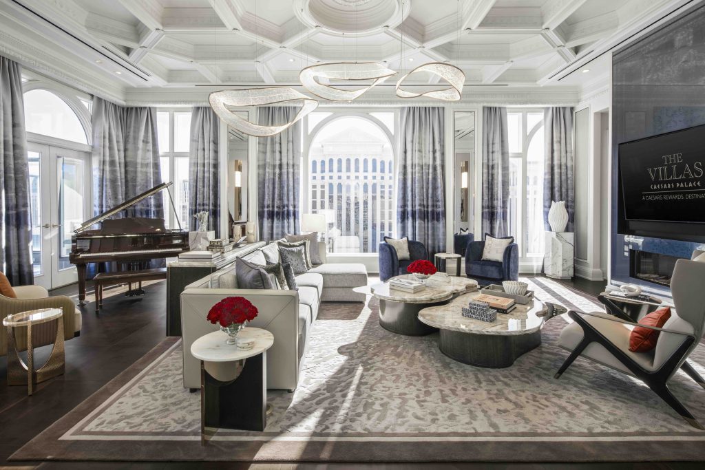 Luxurious living room in Caesars Palace's new Las Vegas villas featuring elegant decor, a grand piano, and stylish furnishings.