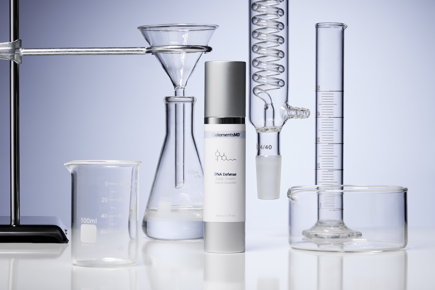 CielementsMD DNA Defense daily cream surrounded by laboratory glassware, emphasizing skincare science for UVA protection.