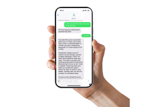 A person holding a smartphone displaying a text conversation about baby sleep concerns and parenting support.
