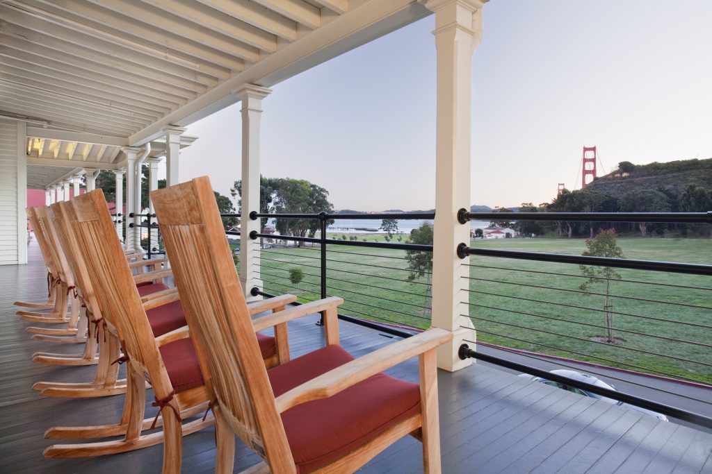 Relaxing rocking chairs with a view of the Golden Gate Bridge and lush greenery, perfect for a stay during Super Bowl LX.