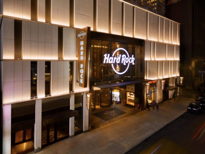 Hard Rock Hotel New York entrance at night, featuring illuminated signage and a modern architectural design.