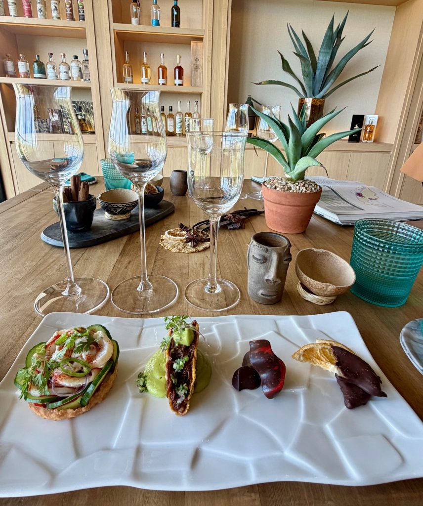 A beautifully arranged platter showcasing gourmet dishes alongside elegant glassware and decorative items in a warm setting.
