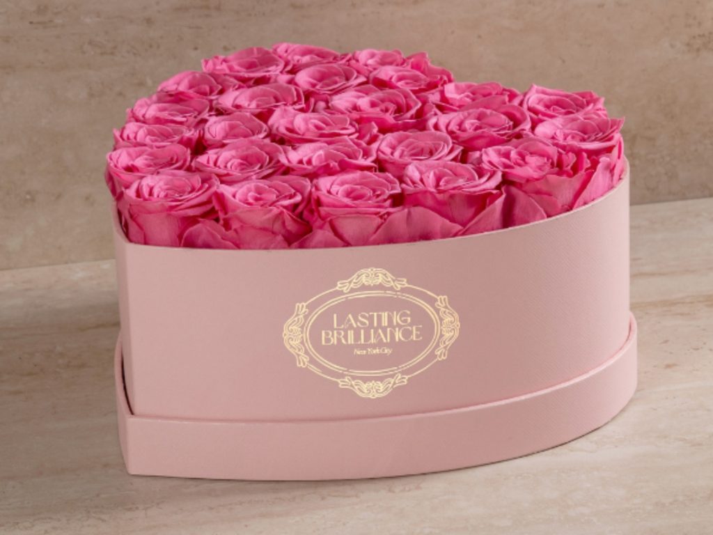 Heart-shaped box filled with vibrant pink roses, featured in the Wrapped in Romance Valentine’s Day gift guide.