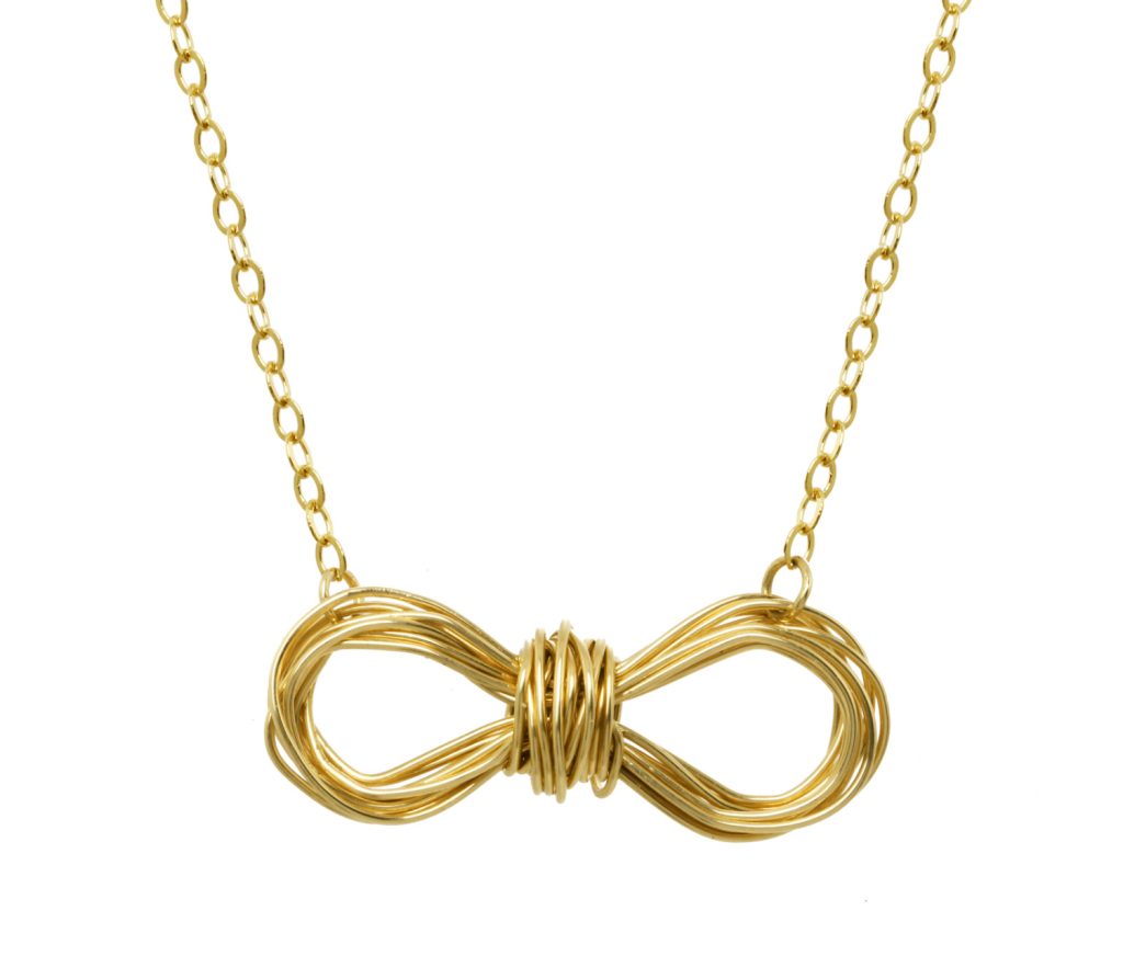 Gold bow necklace with intertwined design, perfect for Valentine's Day gifting.