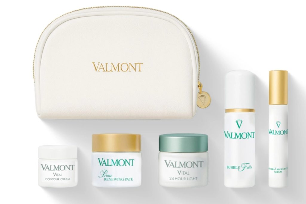 Valmont skincare products displayed in a stylish white pouch, featuring contour, renewing pack, and serum.