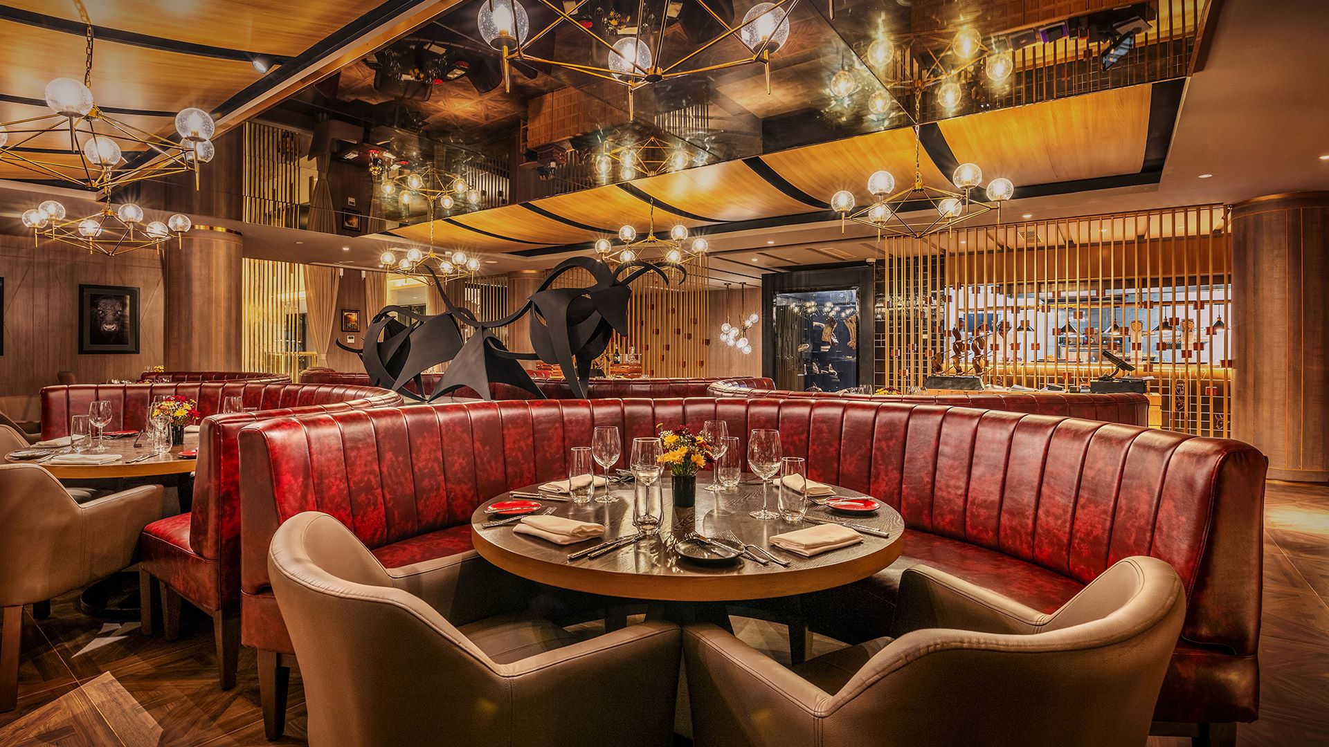 Stylish dining area with plush red booths, elegant lighting, and modern art, showcasing the luxury of Glee Nairobi.