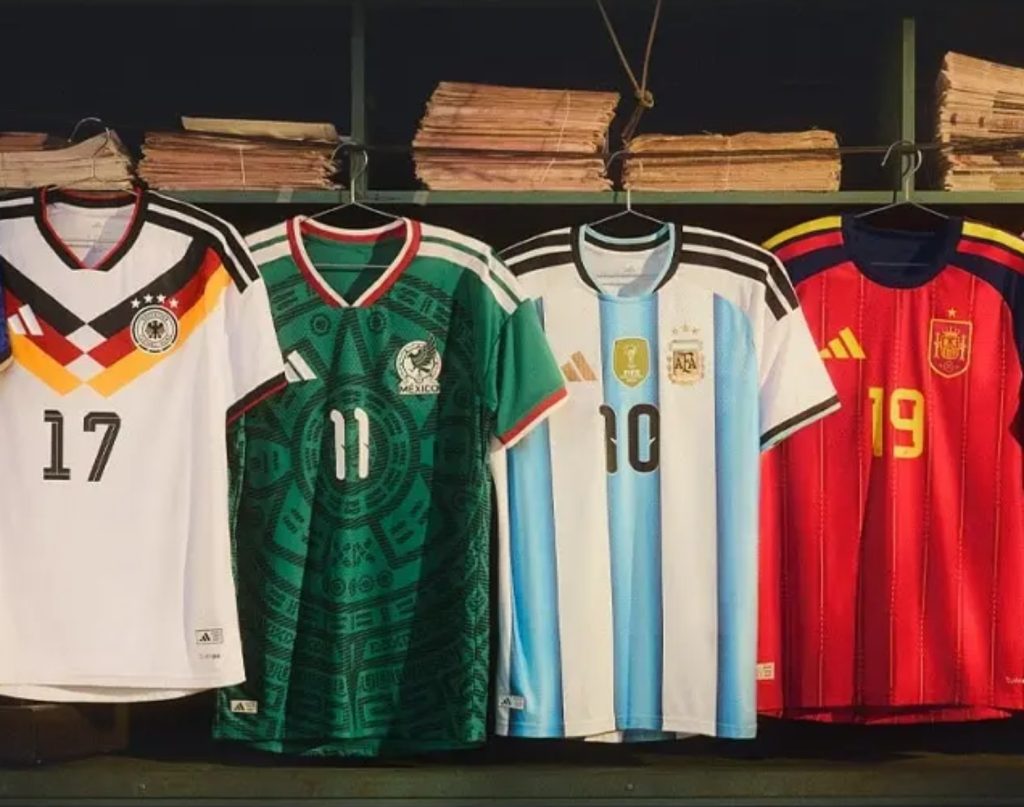 Assorted national soccer jerseys displayed on hangers, featuring designs from Germany, Mexico, Argentina, and Spain.