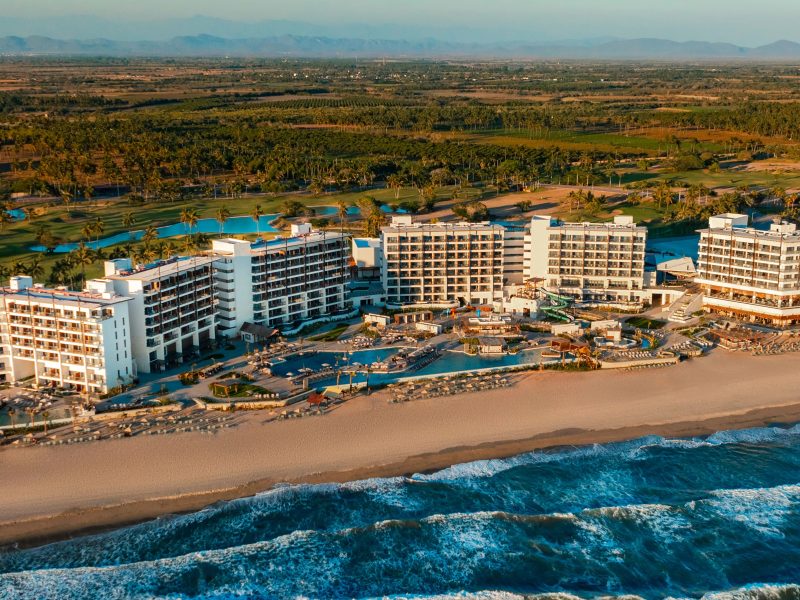 Dreams Estrella del Mar Mazatlán Golf & Spa Resort with beachfront, pools, and golf course surrounded by palm trees.