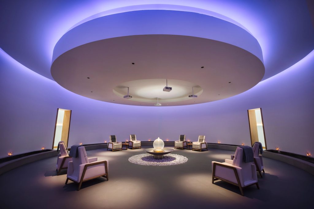 Relaxing spa lounge with contemporary seating and ambient purple lighting at Dreams Estrella del Mar Mazatlán Resort.