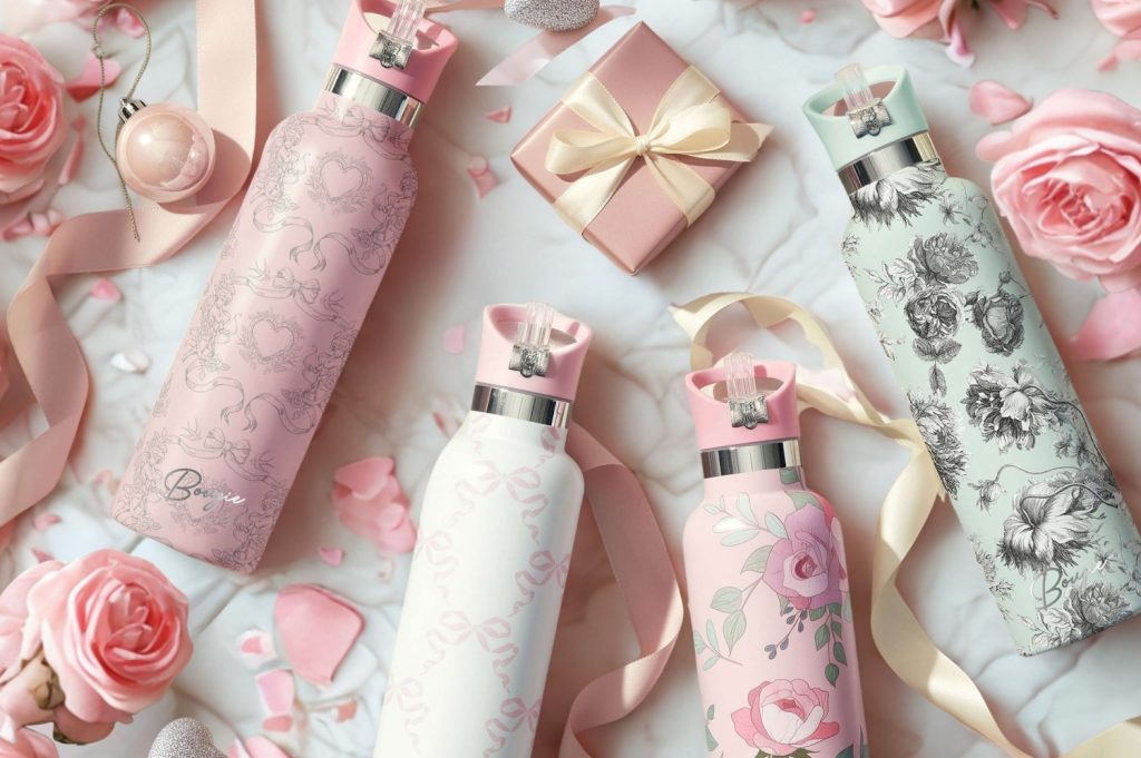 Four decorative water bottles featuring floral and heart designs, surrounded by roses and a gift box for Valentine's Day.