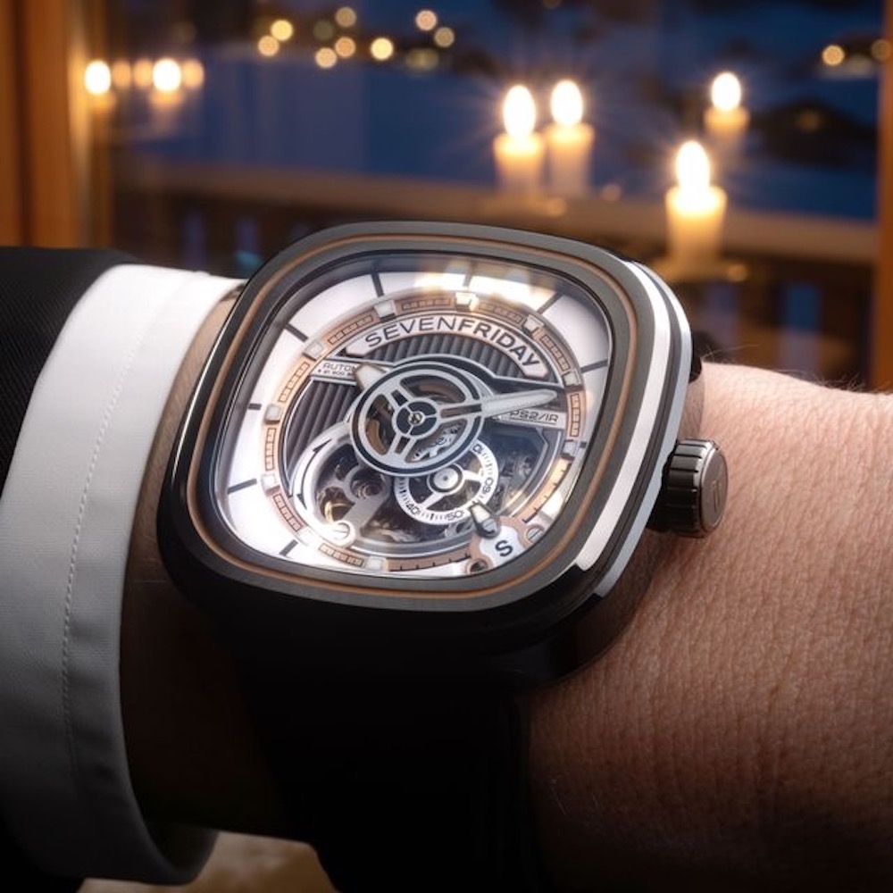 SevenFriday PS2/03 "BC" watch displayed on a wrist, featuring a unique design and luminous elements against a cozy background.