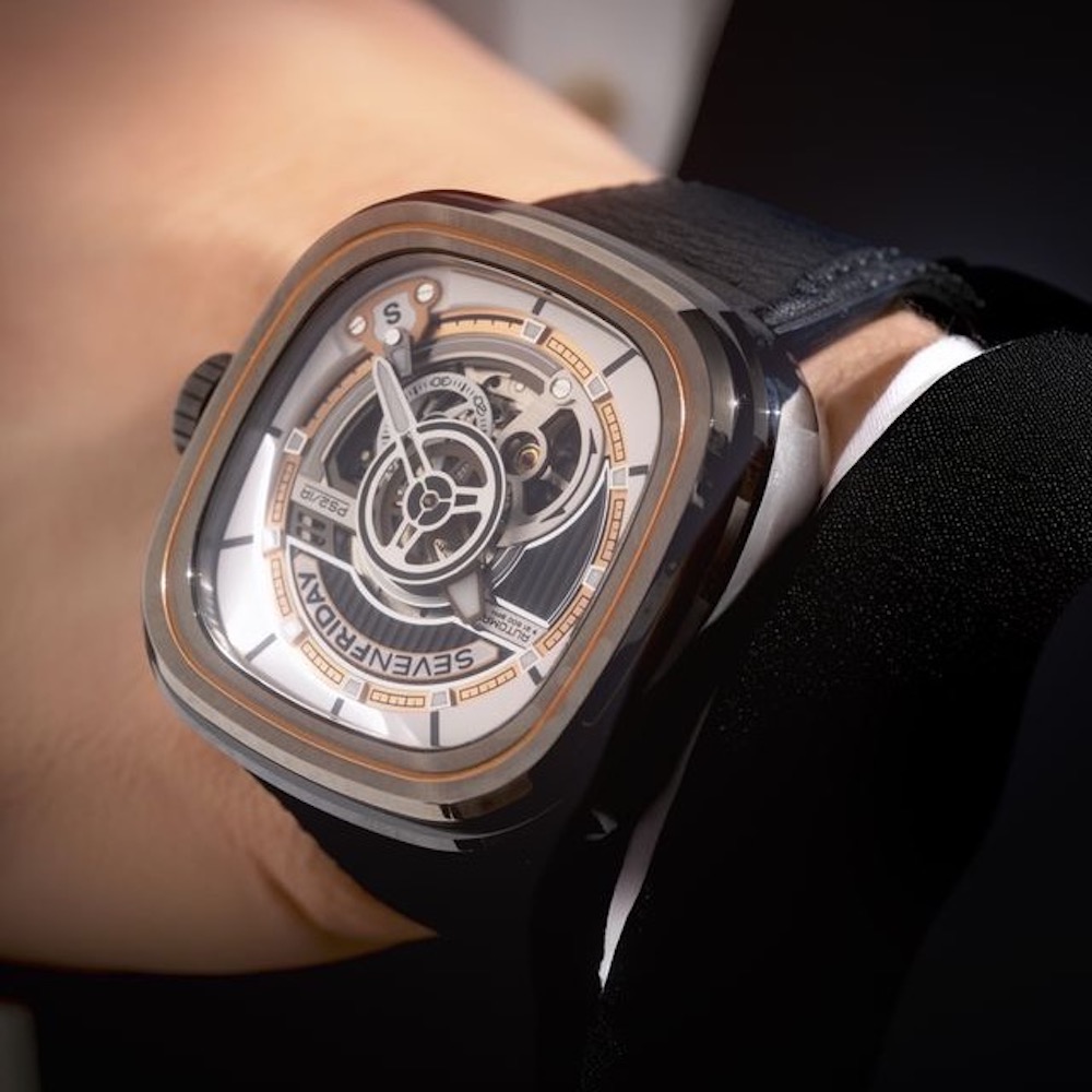 SEVENFRIDAY PS2/03 "BC" watch displayed on a wrist, featuring an intricate dial design and a textured black strap.
