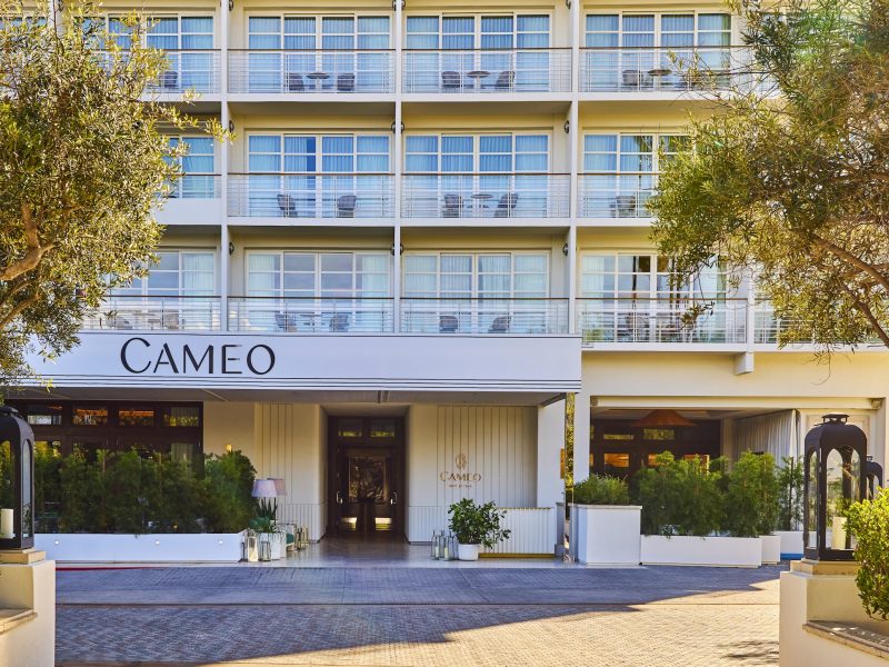 Cameo Beverly Hills entrance featuring stylish architecture, greenery, and the hotel's name prominently displayed.