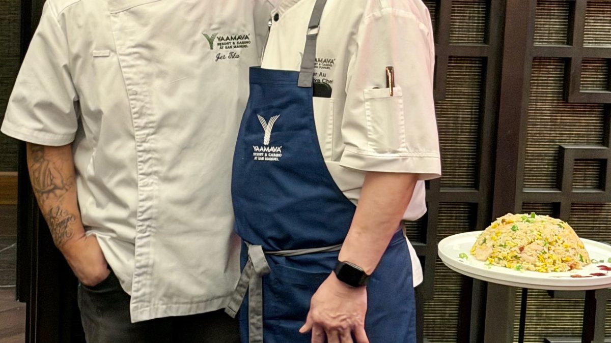 Chefs Jet Tila and another chef pose with a platter featuring a vibrant dish at Yaamava's Lunar New Year celebration.