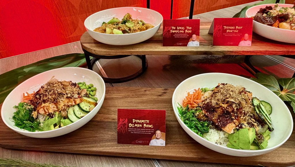 Dynamite salmon bowl with roasted crab meat, served with rice, edamame, and cucumber, alongside other culinary offerings.