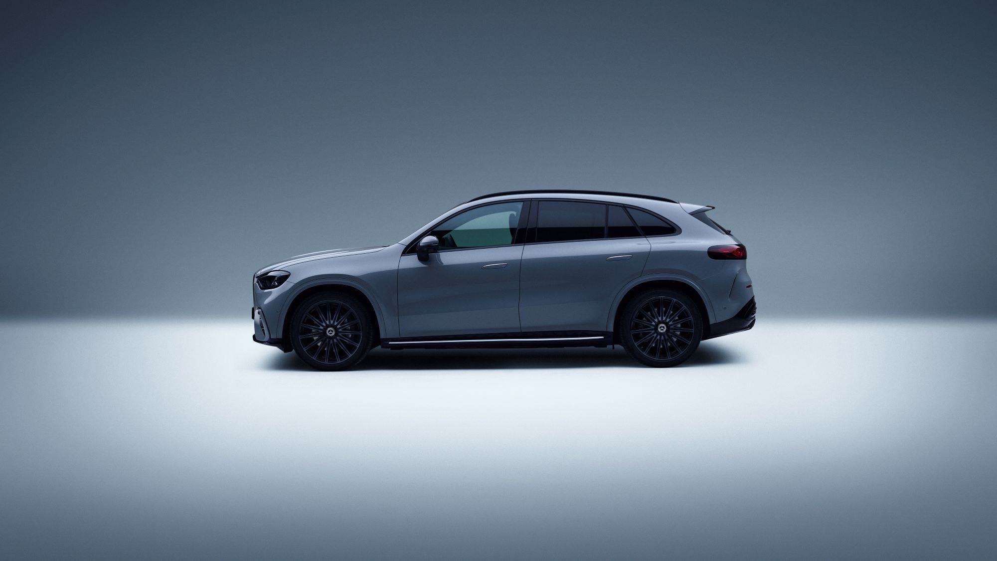 A sleek Mercedes-Benz SUV in profile view, showcasing modern design with a gray exterior and stylish black wheels.