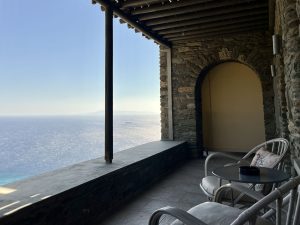 Balcony view of the Aegean Sea from the Aegean Castle hotel, showcasing a serene spot with comfortable seating.