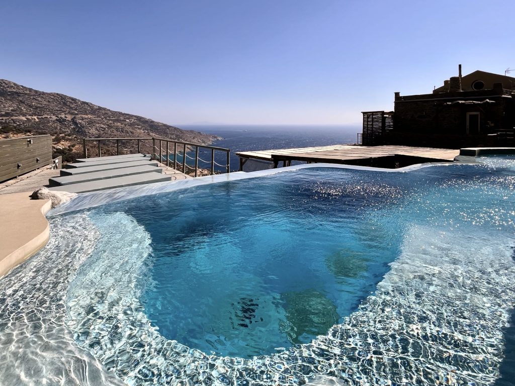 Infinity pool overlooking the Aegean Sea, with mountains in the background, at Aegean Castle boutique hotel.