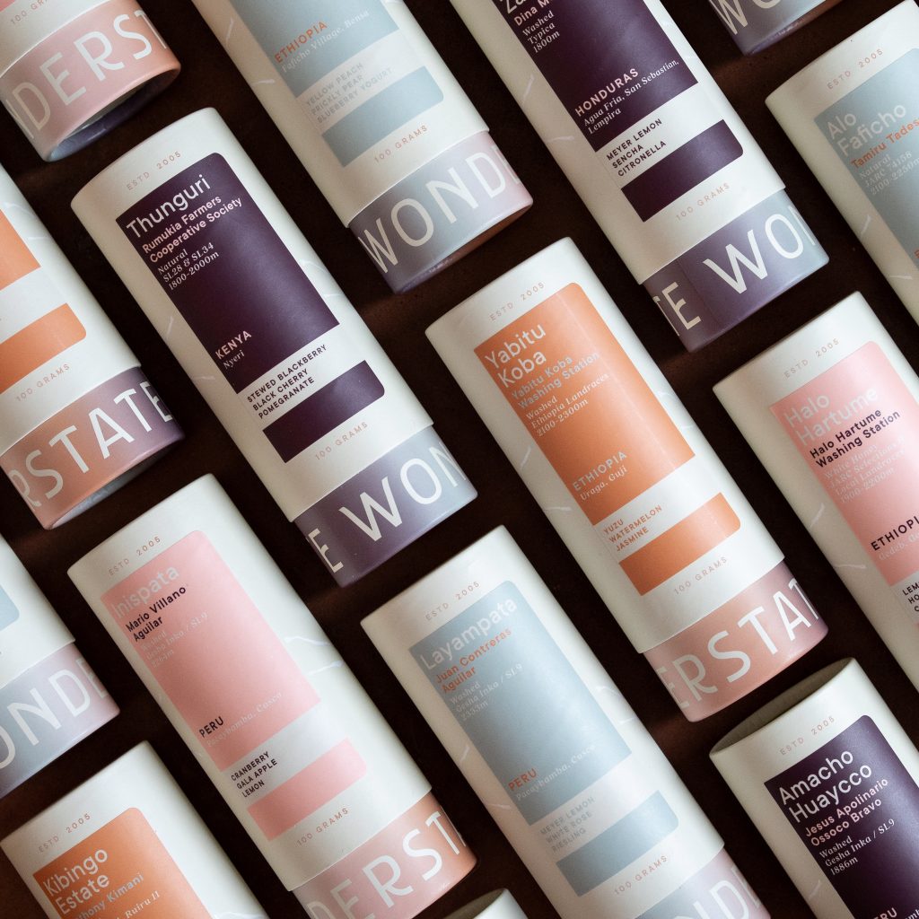 Colorful coffee packaging featuring various blends from Wonderstate Coffee, labeled with their origins and tasting notes.