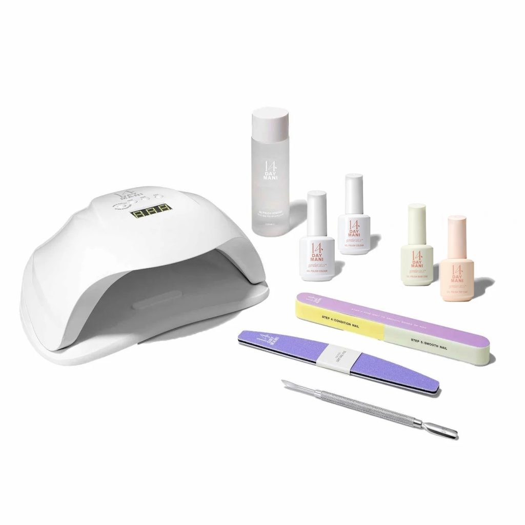 Nail care kit featuring a UV lamp, nail polishes, and manicure tools for a professional at-home nail treatment.