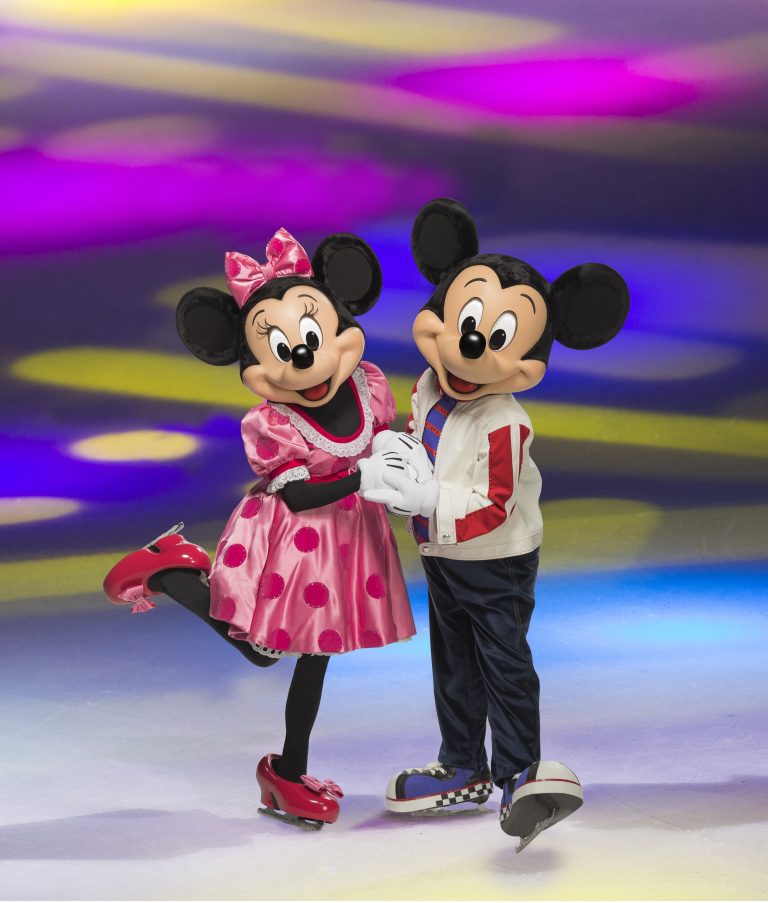 Minnie and Mickey Mouse skating together on ice, dressed in colorful outfits against a vibrant, colorful background.