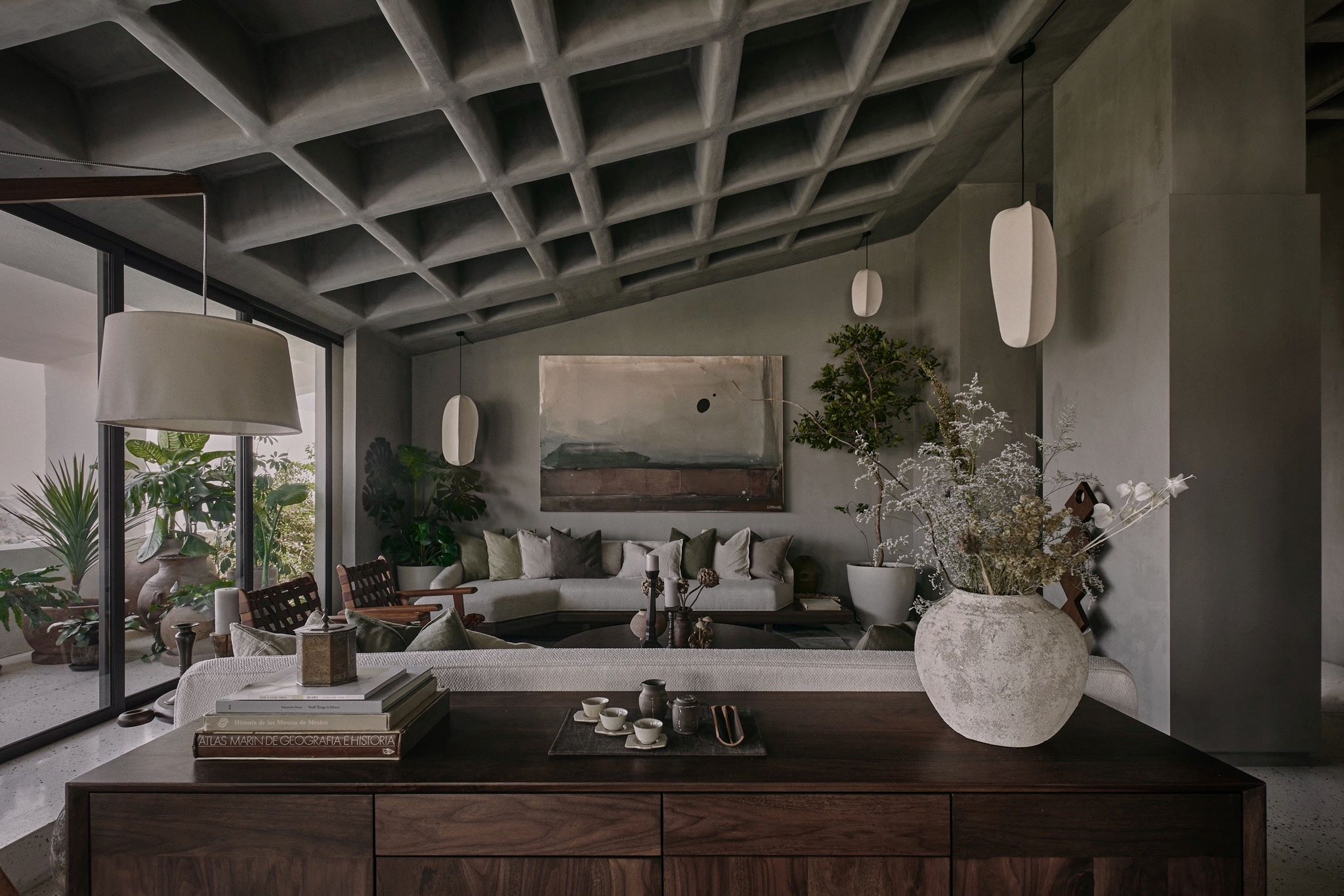 Modern living room featuring a textured ceiling, elegant furnishings, plants, and decorative details that showcase luxury design.