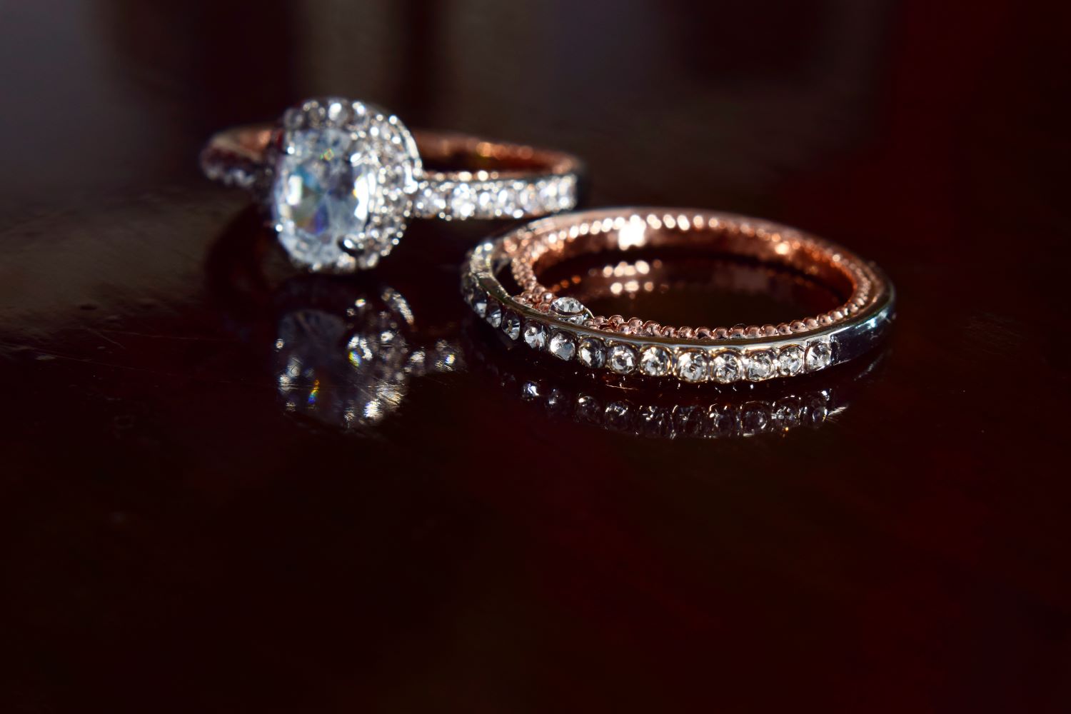 Engagement ring with a halo setting and a matching band, both featuring intricate diamond details.