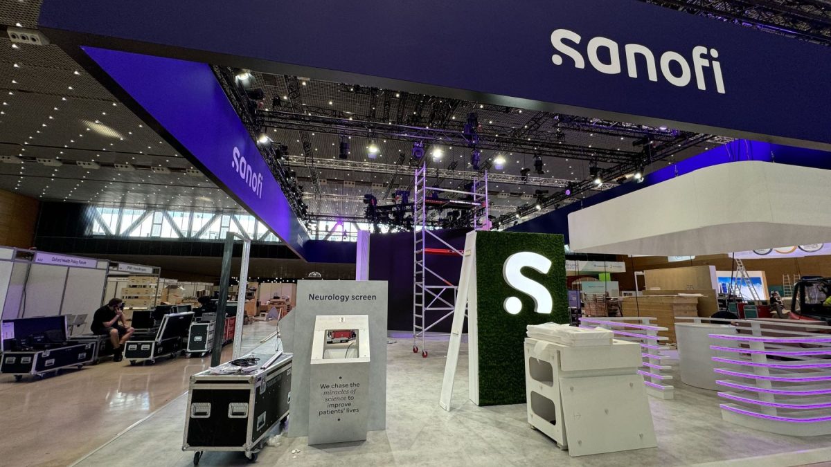 Sanofi exhibition booth featuring a neurology screen display and branding elements, set up for an event venue.