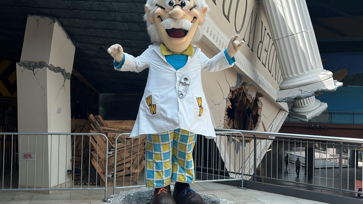 A character in a lab coat stands on a pedestal, surrounded by a playful science-themed environment at WonderWorks Destiny.