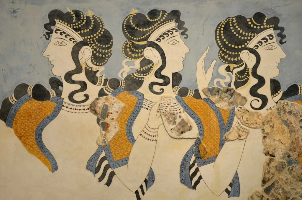 Minoan fresco depicting three women with intricate hairstyles and colorful garments, showcasing ancient art from Crete.