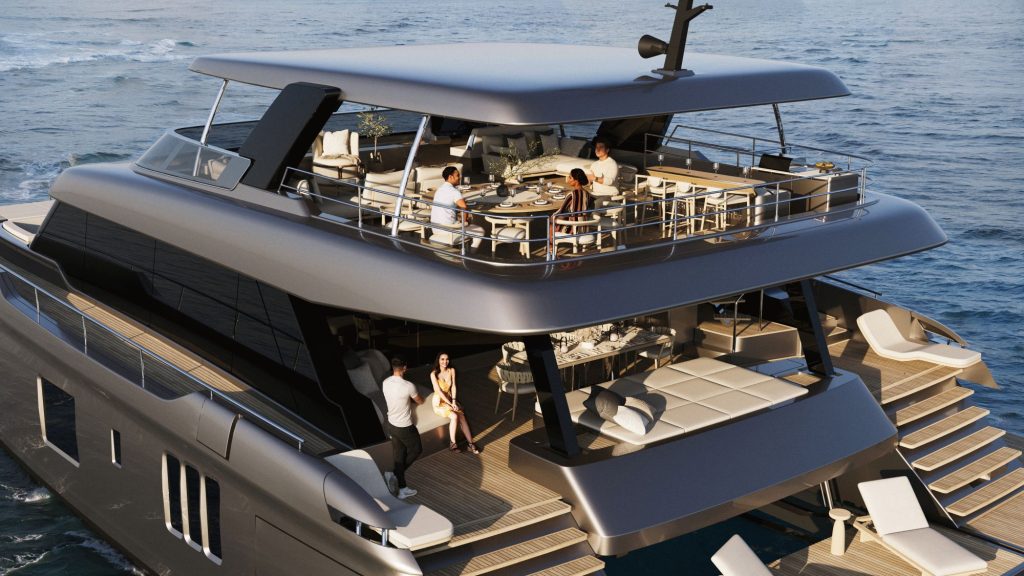 A luxurious eco-yacht features an outdoor dining area with people enjoying a meal and lounging on the deck by the ocean.