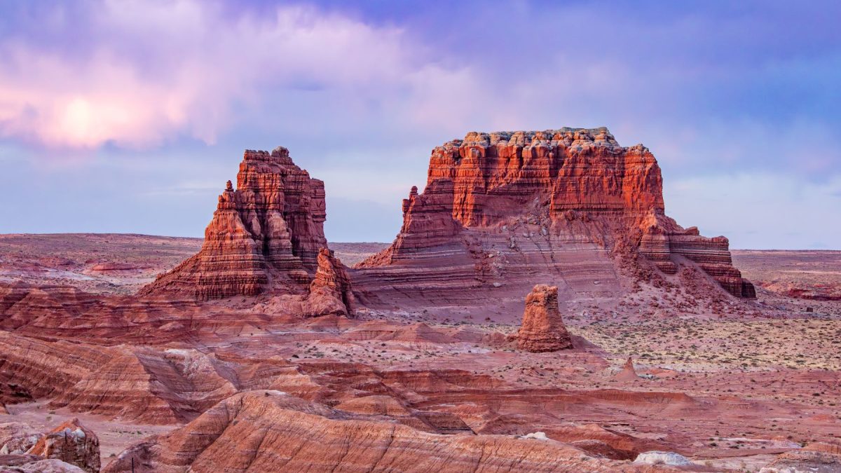 Unique rock formations in a desert landscape near St. George, Utah, with colorful skies at dusk.