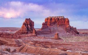 Unique rock formations in a desert landscape near St. George, Utah, with colorful skies at dusk.