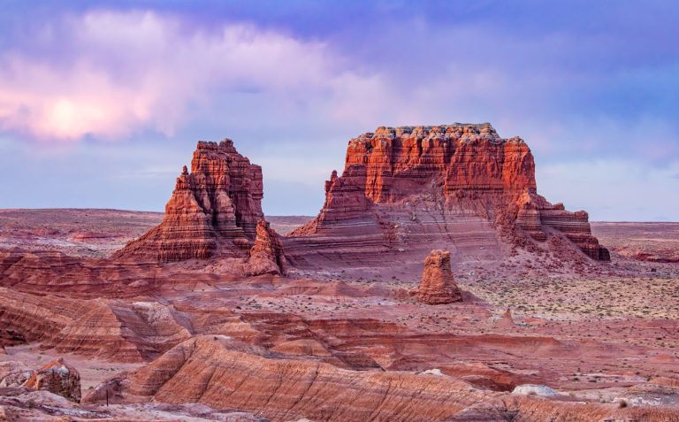 Unique rock formations in a desert landscape near St. George, Utah, with colorful skies at dusk.