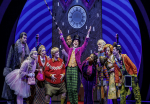 Cast members performing in a vibrant scene from Charlie and the Chocolate Factory at Richmond Theatre.