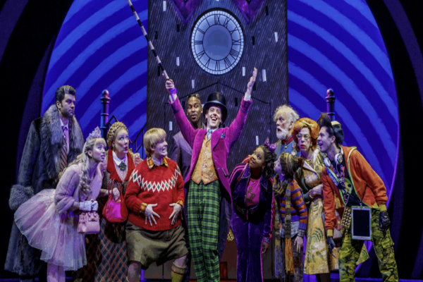 Cast members performing in a vibrant scene from Charlie and the Chocolate Factory at Richmond Theatre.